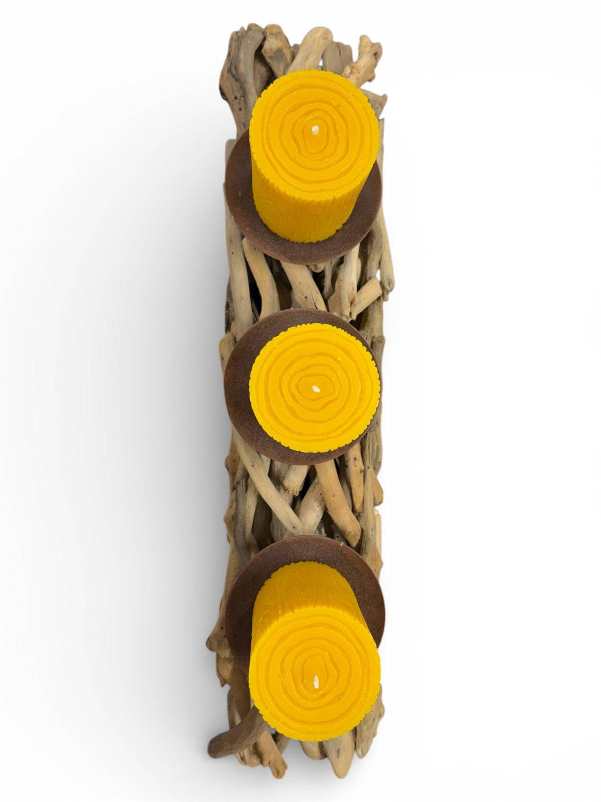 Decorative candle holder made of driftwood with yellow candles on a white background