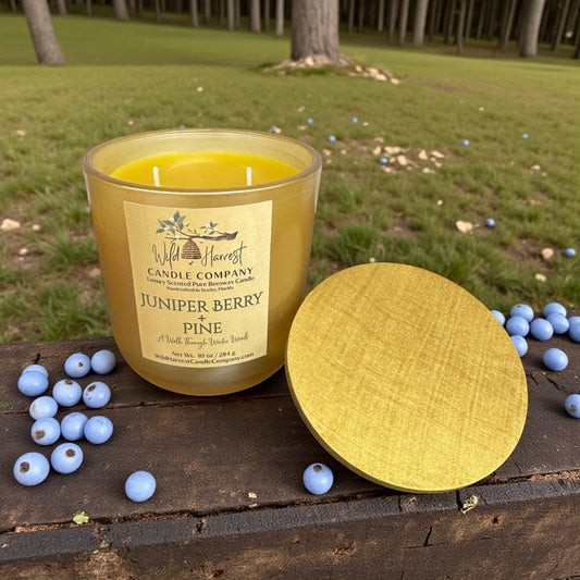 Juniper Berry & Pine candle with a label on a wooden surface outdoors