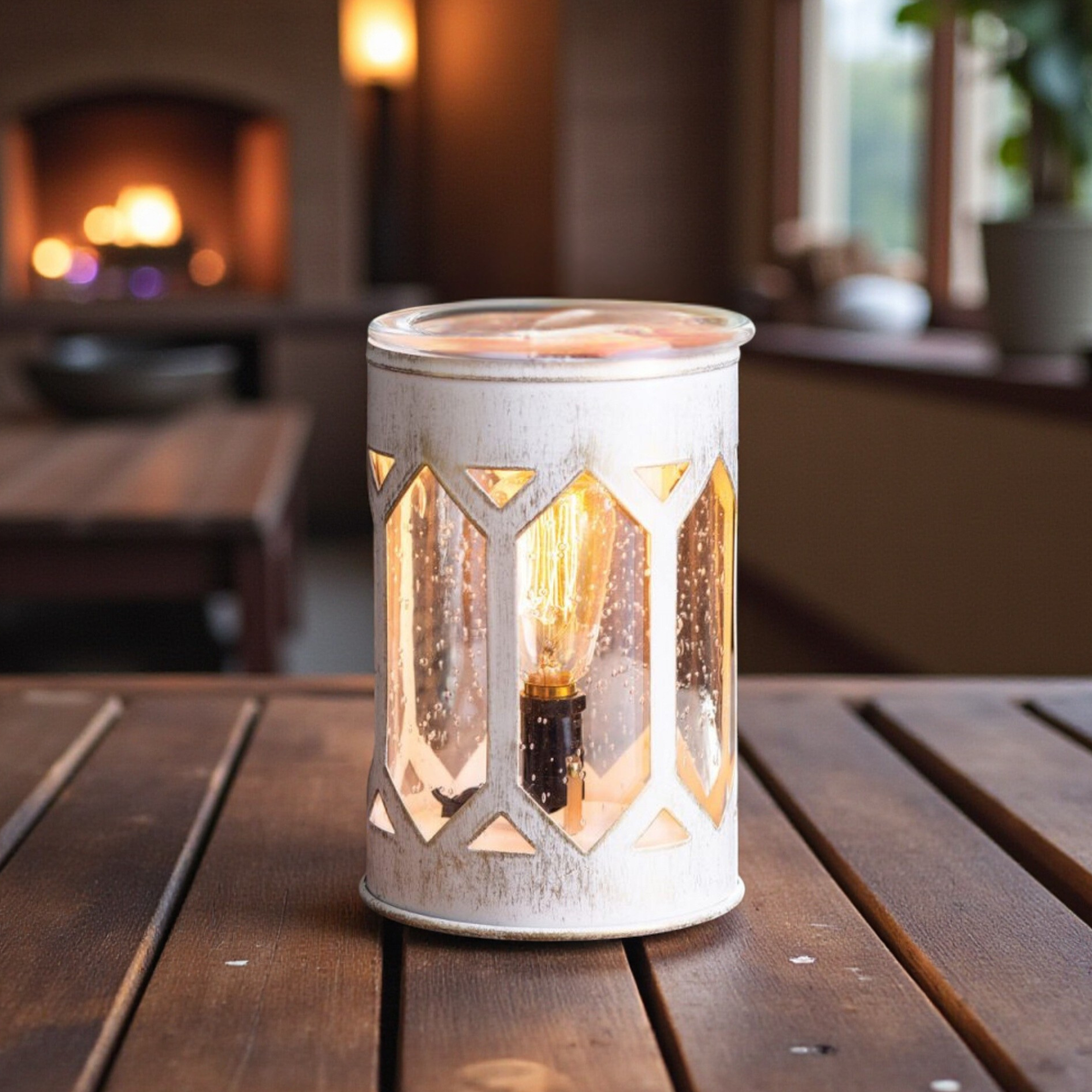 Decorative lantern with a lit bulb on a wooden table in a cozy indoor setting.