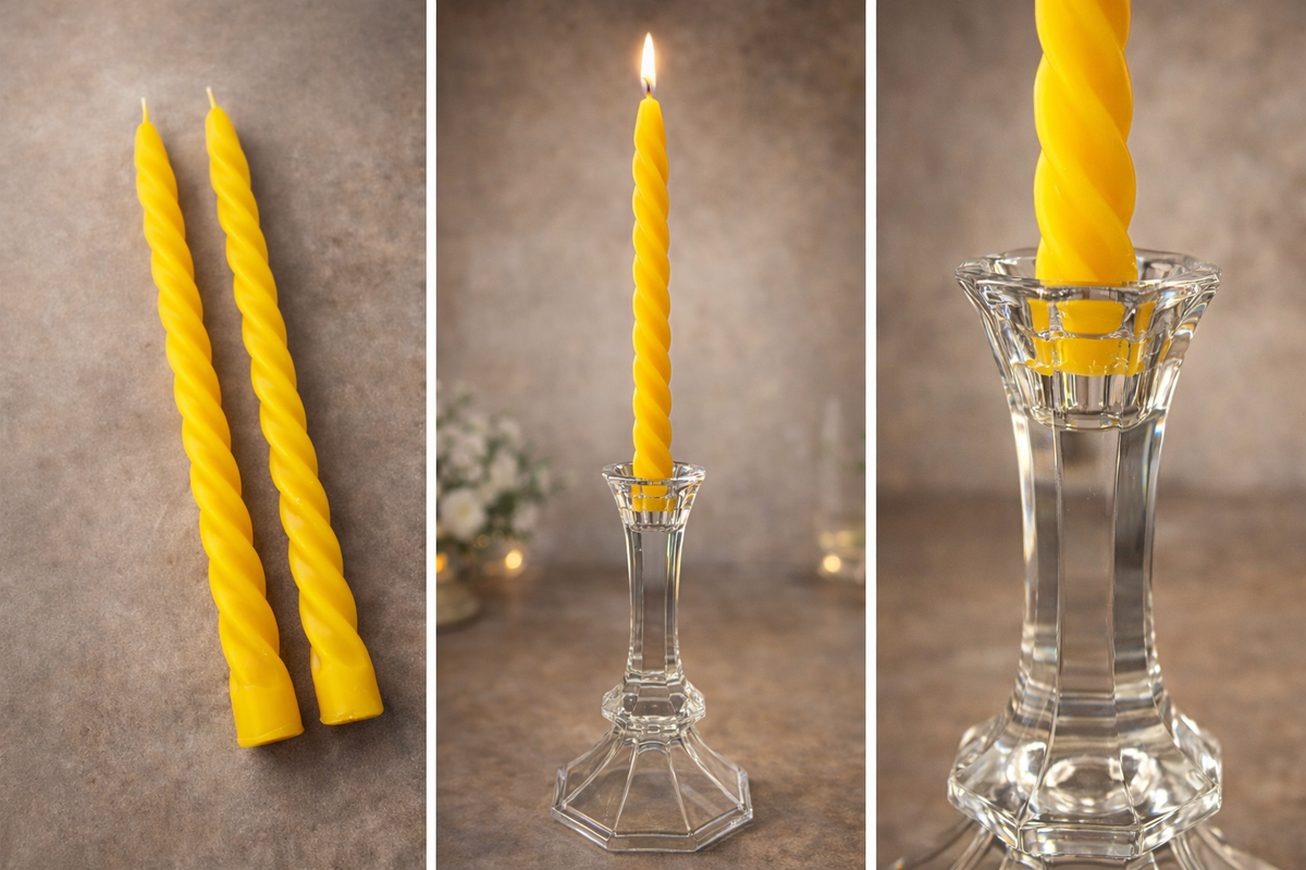 Yellow candles on a textured surface with a glass candle holder.