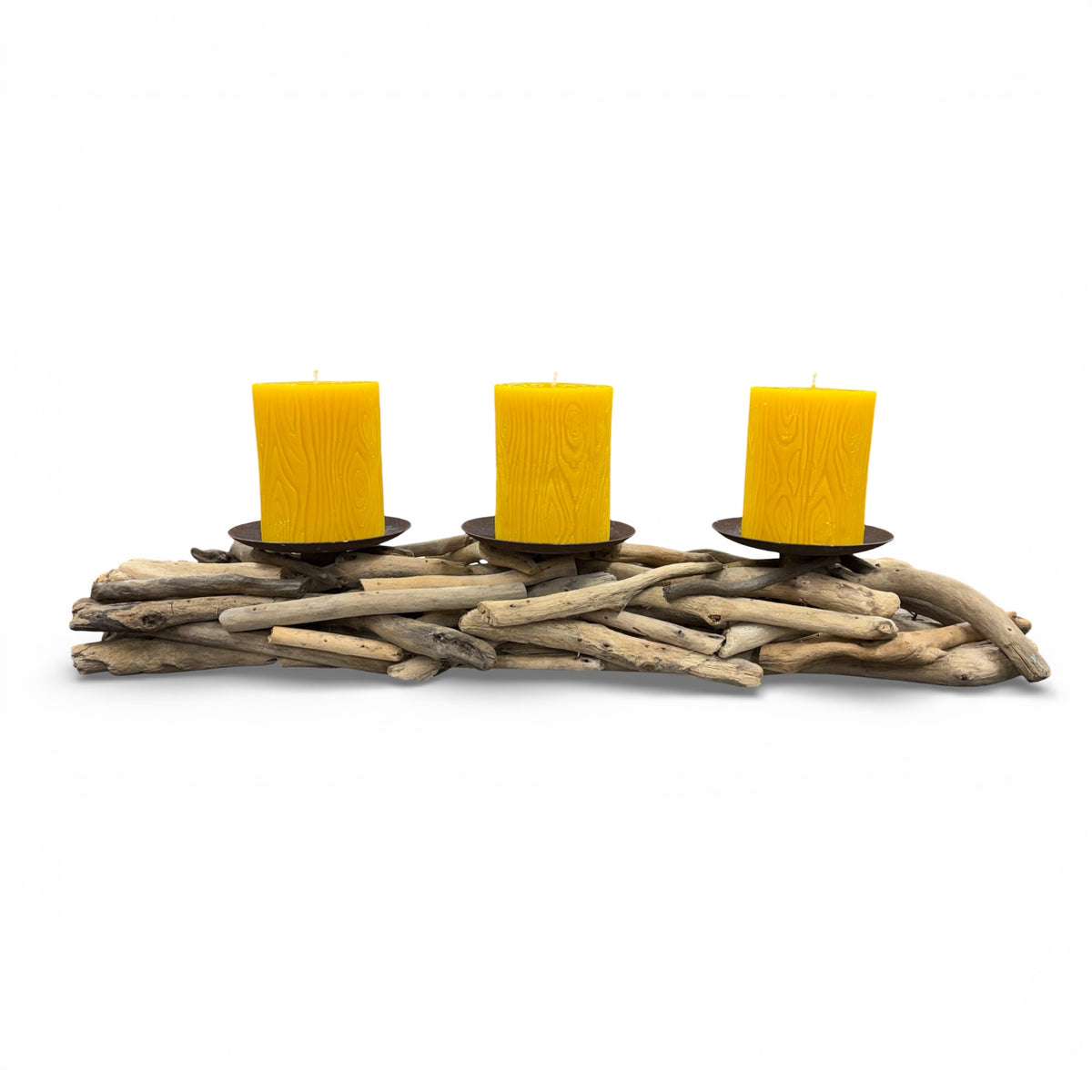Three yellow candles in black holders on a driftwood base against a white background